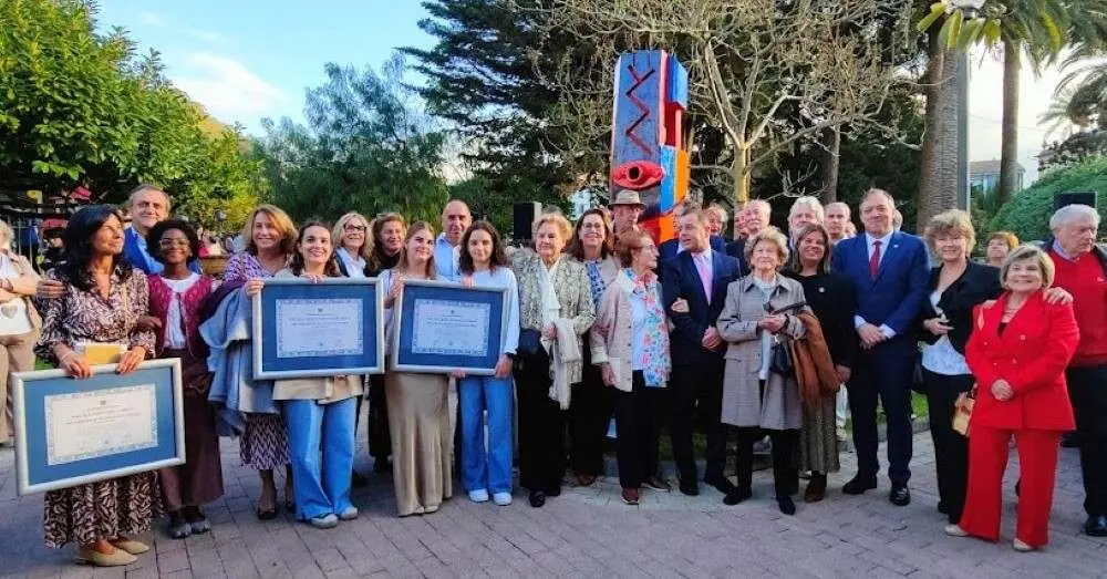 Posado ante la estatua homenaje.