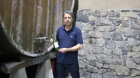 Cele Foncueva, en el llagar de Sariego, sujetando una de las botellas de la marca
