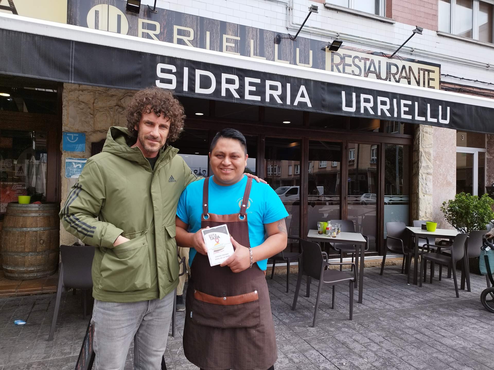 Iván Pérez, con Gilson Pineda, propietaria de la Sidrería Urriellu